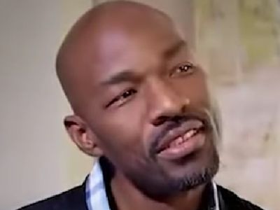 Jay Tucker is looking on at something with his head slightly tilted.